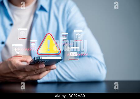 System warning and cybersecurity alert concept on smartphone. Digital risk management and data Stock Photo