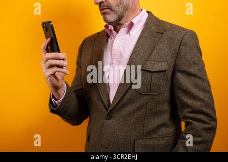 Man looking at smartphone with concentration in side profile Stock Photo