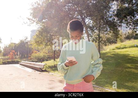 young african american woman using cell phone Stock Photo
