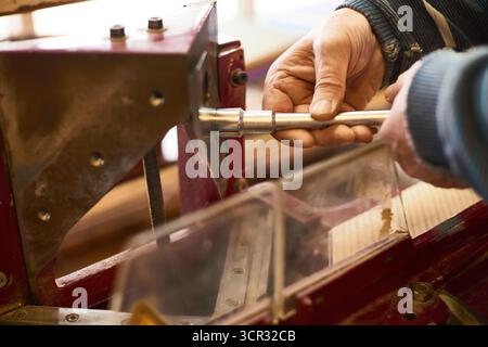 Man Operating Industrial Wood Cutting Machine Stock Photo