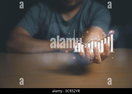 Business growth and successull concept. Businessman or trader is showing a growing virtual hologram stock, invest in trading. Planning and strategy, S Stock Photo