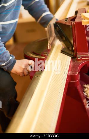 Man Operating Wood Cutting Machine in Workshop Stock Photo