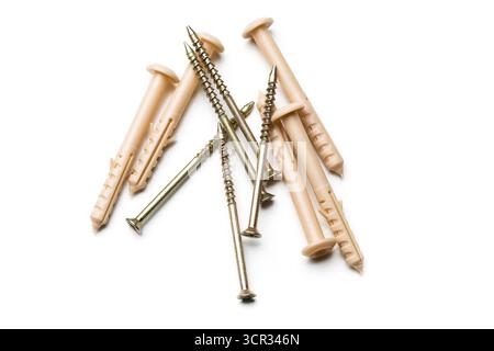 Assorted screws and wall anchors arranged on a white background for construction projects Stock Photo