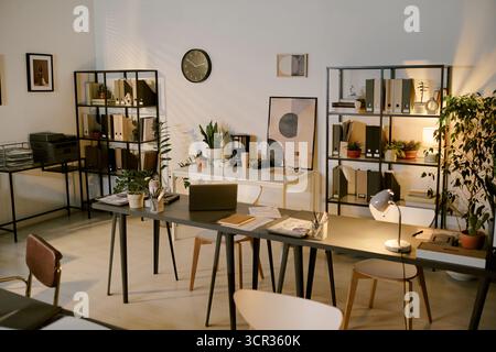 Modern Office Interior Featuring Organized Desks and Shelves with Documents Stock Photo