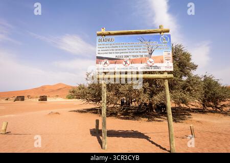 The Deadvlei sign, Namibia - 27 August,2025: explains the history of the clay pan, how its ancient camelthorn trees died, and the formation of the sur Stock Photo