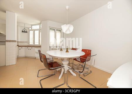 Elegant dining room with an oval   table and blue velvet chairs, ideal for formal dinners with guests Stock Photo