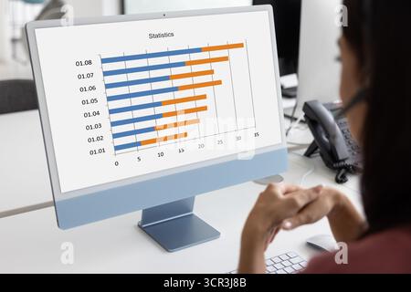 Woman reviewing bar chart titled Statistics, close up Stock Photo