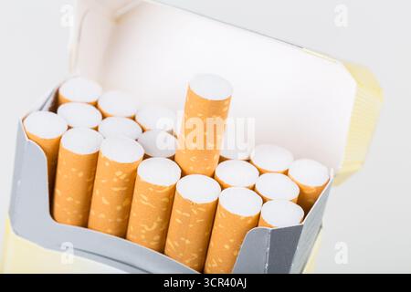 Cigarette pack with cigarettes arranged neatly in a box for display in a neutral setting Stock Photo