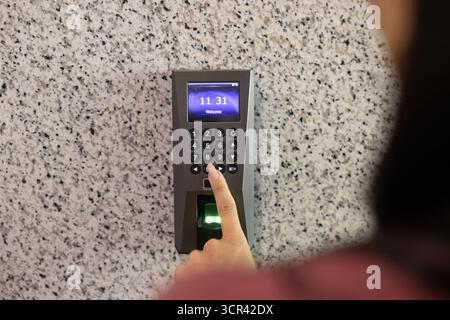 Woman entering office room using keyless access system Stock Photo