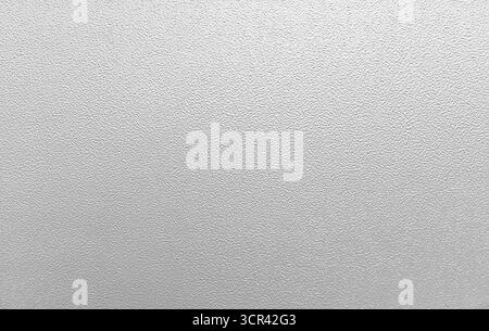 Detailed close-up photograph of a gray painted metal surface showcasing a fine granular texture. Ideal for backgrounds, design projects, or wallpapers Stock Photo