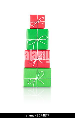Pile of red and green wrapped gift boxes tied with white string, isolated on white background with reflection. Stock photo. Stock Photo