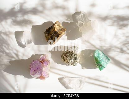 Colorful raw crystals with natural shadows on white background Stock Photo