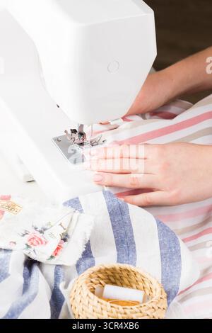 Creating a sewing project using a modern sewing machine at home Stock Photo