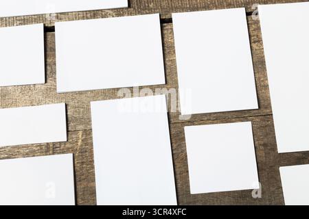 Blank rectangular cards arranged on a wooden surface with natural lighting Stock Photo