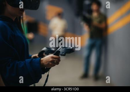 Person Immersed in Virtual Reality Experience Using Advanced Controllers Stock Photo