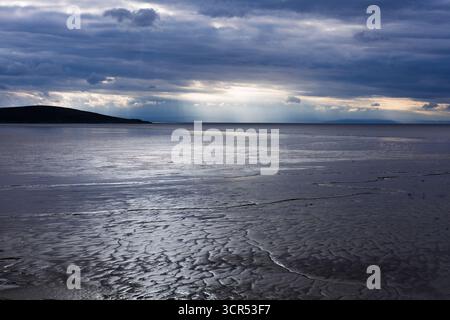 Dramatic light over the Bristol Channel. Low tide reveals the vast mudflats, creating a unique landscape. Stock Photo