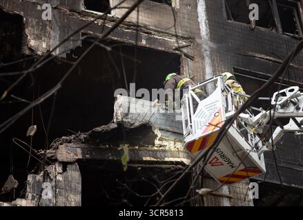 Rescue workers seen actively clearing debris from a heavily burned and structurally damaged Kyiv residential building following a Russian air attack, alongside sections with shattered windows. Following a massive shelling attack on Kyiv by Russia on Sunday night, using UAVs and missiles, four fatalities have been confirmed, including a 12-year-old child, along with 13 injured persons. Rescue operations at the strike sites, which affected 32 locations—including residential buildings, civilian infrastructure, and the Representation of the European Union in Ukraine—have now concluded. The attack Stock Photo