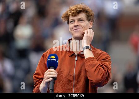 Runner up Jannik Sinner smiles as he makes his speech  at the US Open Championships 2025 trophy presentation, USTA Billie Jean King National Tennis Ce Stock Photo