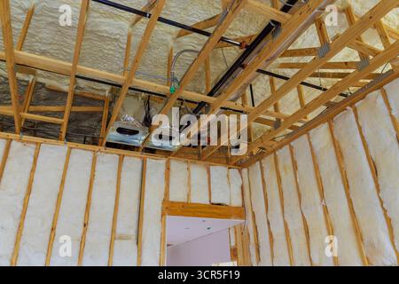 Picture of Exposed ductwork wooden beams in renovated attic showcase insulation ...