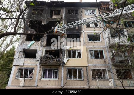 Rescue workers seen actively clearing debris from a heavily burned and structurally damaged Kyiv residential building following a Russian air attack, alongside sections with shattered windows. Following a massive shelling attack on Kyiv by Russia on Sunday night, using UAVs and missiles, four fatalities have been confirmed, including a 12-year-old child, along with 13 injured persons. Rescue operations at the strike sites, which affected 32 locations-including residential buildings, civilian infrastructure, and the Representation of the European Union in Ukraine-have now concluded. The attack Stock Photo