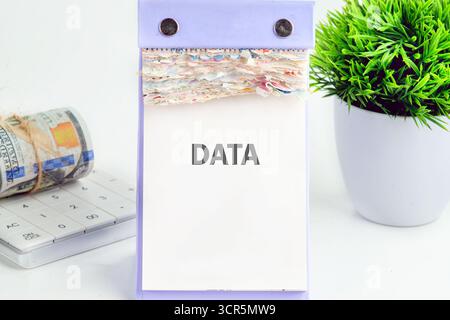 DATA word written on a desktop calendar on a white background. Financial business analytics concept. Stock Photo