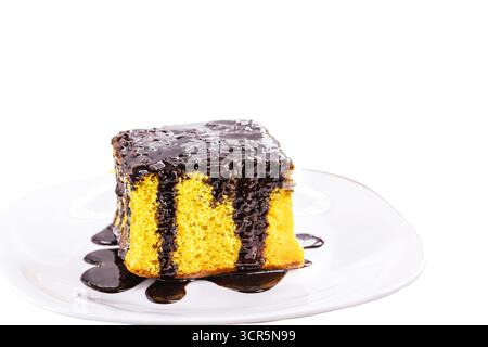 slice of carrot cake with creamy chocolate icing and sprinkles, on isolated white background, copyspace typical of Brazilian June festivals, homemade Stock Photo