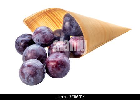 Fresh plums falling from an paper cone isolated on white with clipping path included Stock Photo