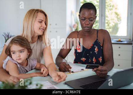 Family receiving financial advice from consultant at home Stock Photo