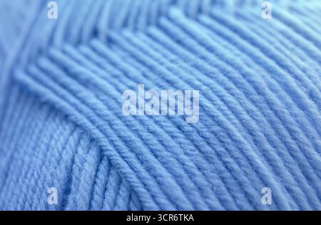 Close-up Texture of Blue Wool Thread. Winter yarn in a ball background. Handicraft concept, hobby, online knitting course. Stock Photo