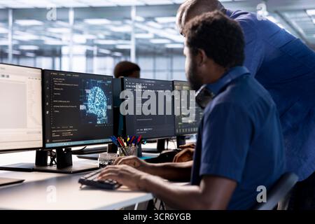 Team of server farm coworkers using AI systems to input data faster during complex computational tasks. Teamworking data center colleagues using artificial intelligence parallel processing tech Stock Photo