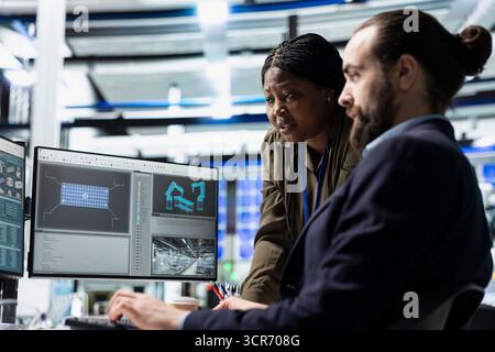 Multiethnic team of engineering specialists working together for solar power manufacturing process, strengthening infrastructure and business development. Renewable energy in a plant. Stock Photo
