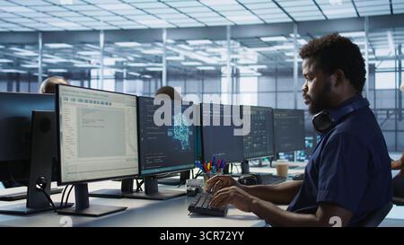 Woman assisting data center programmer in solving tasks, maintaining company network infrastructure. Supervisor in server room helping employee ensuring optimal system performance Stock Photo