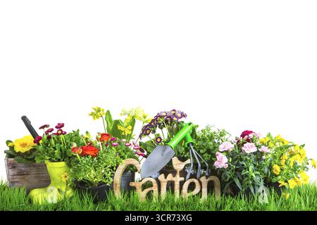 word Garden with spring flowers and gardening tools in the garden, composing Stock Photo