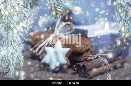 Cinnamon star, gingerbread cookies and cinnamon sticks as Christmas decorations, composing Stock Photo