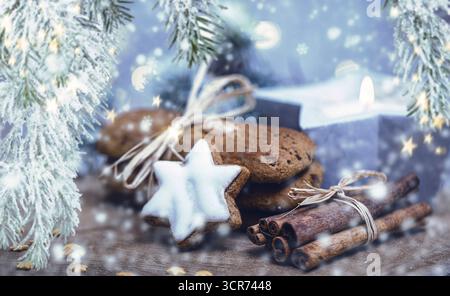 Cinnamon star, gingerbread cookies and cinnamon sticks as Christmas decorations, composing Stock Photo