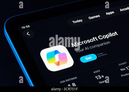 Microsoft Copilot app page on App Store for iPad, Apple Liquid Glass design in iOS 26 showcased with dark mode. Stafford, United Kingdom, September 29 Stock Photo