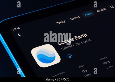 Google Earth app page on App Store for iPad, Apple Liquid Glass design in iOS 26 showcased with dark mode. Stafford, United Kingdom, September 29, 202 Stock Photo