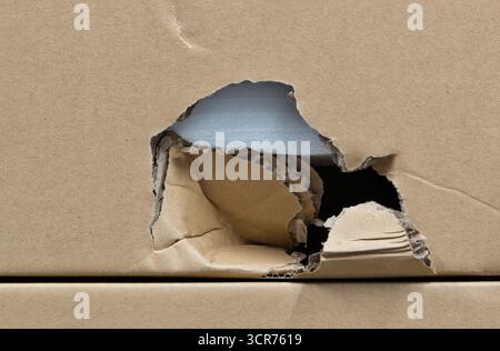 Damaged cardboard box broken shipping freight transportation quality control. Stock Photo