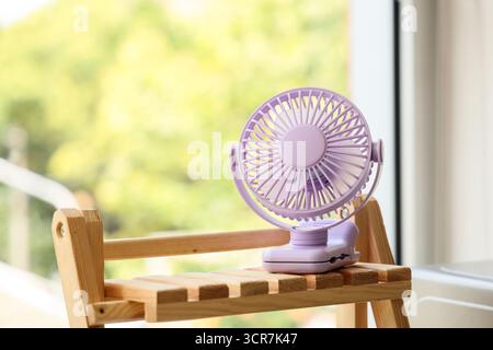 Lilac mini fan on shelf in kitchen, closeup Stock Photo