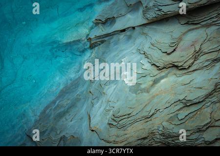 Striking blue stone texture reveals layers of geology and time Stock Photo