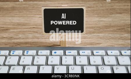 AI Powered Concept on Mini Chalkboard Above a Computer Keyboard Representing Artificial Intelligence Technology Stock Photo