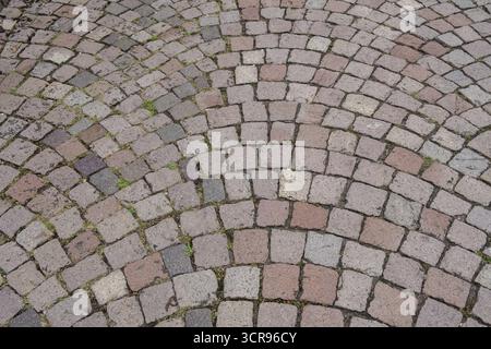 Floor covering made of paving stones with an arched pattern in grey and reddish tones, background, texture, Germany Stock Photo