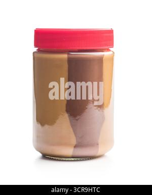 Two-tone nut chocolate spread in jar isolated on a white background. Stock Photo