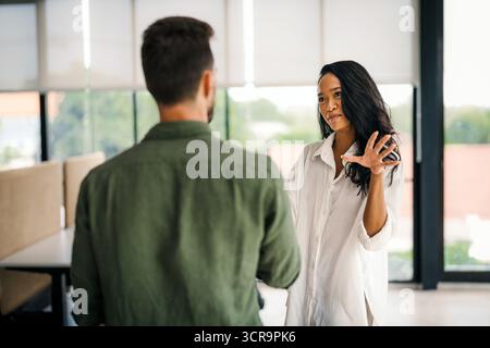 Happy young successful startup, business people of different human races chatting at office together Stock Photo