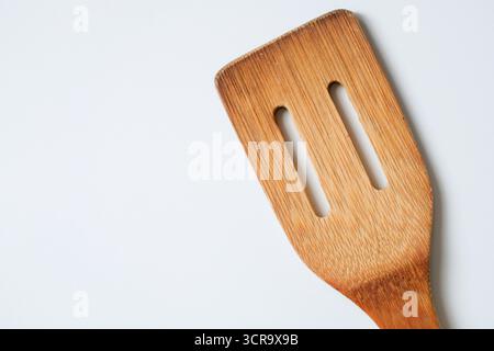 Close-up of bamboo kitchen spatula isolated on white background Stock Photo