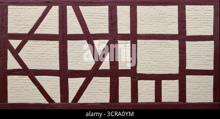 Restored, newly painted old timber frame - beams filled with bricks Stock Photo