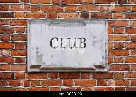 Club Concept. Copy space. Word club written on a plaque on a weathered brick wall.. Stock Photo