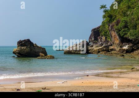 Plastic waste and garbage washed ashore on a beautiful remote tropical beach. Stock Photo
