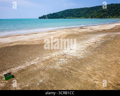 Environmental issue of plastic waste washed up on a beautiful Malaysian coastline Stock Photo