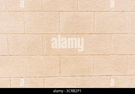 Abstract background of a beige brick wall. A sample of brick laying. Beautiful brick texture. model of building material. A copy of the space. Stock Photo